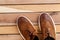 Brown mens shoes on wooden background. top view