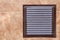 Brown metal industrial panel with ventilation grilles, closeup photo, front view. Detail of architecture design. Air circulation s