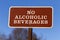 A brown metal plate with `No Alcoholic Beverages` notice on.