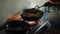 Brown Nepali Indian young girls cook pasta in the kitchen in a large saucepan for children of the orphanage. Close-up