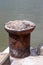 Brown old metal cabinet mooring cement shore on the background of water