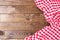 Brown old vintage wooden table with framed red checkered tablecloth.Thanksgiving day and Cristmas table concept. Top view.
