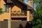 Brown open wooden balcony on a brick wall of a private house