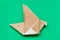 Brown origami paper in flying bird shape