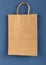 Brown paper bag on a blue