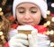 A brown paper cup of coffee with a white plastic lid close-up in the hands of a young cute girl. Hot drinks. Winter. Coldly. The