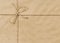 Brown paper parcel or package background with rope or string, copy space, horizontal