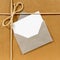 Brown paper parcel with silver envelope white message card