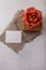 Brown paper present box, fabric rose flower, blank postcard on white background. Valentines day, birthday or wedding surprise