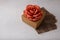 Brown paper present box, fabric rose flower on white background. Valentines day, birthday or wedding surprise