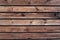 Brown parallel planks with wood texture, wood screws and nails.