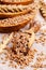 Brown peeled wheat grits on a textile background