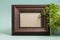 Brown photo frame with plant