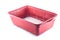 Brown plastic deep tray with silica gel litter for cat litter with white and pink granules on a white background, isolate