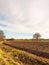 brown ploughed agricultural field outside farm landscape sky ground dirt tree