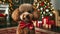 A brown poodle with a red bow tie sits adorably in front of a Christmas tree with gifts.