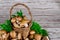 Brown portobello mushrooms in wicker wooden basket with grass decoration