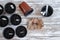 Brown pots with black soil, white labels and seeds of plants on sackcloth background.