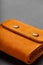 Brown purse, wallet made of genuine leather Nubuck on a dark background. Elements of leather craft products handmade
