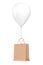 Brown Recycled Paper Shopping Bag Floating with White Hellium Balloon. 3d Rendering