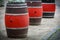 Brown and red big barrels standing on street pavement