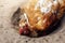 Brown relaxing chicken bathes in the sand