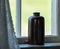 Brown retro ceramics bottle on window