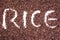 Brown rice in alphabet writing rice background texture