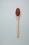 Brown rice. GABA rice in wooden spoon on light textured background. Top view, place for text
