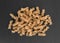 Brown rice pasta fusilli on a slate background