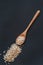 Brown rice in wooden or bamboo spoon top view