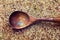 brown rice in a wooden spoon