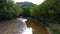 Brown River with Muddy Water in Mangrove Forest in Park with Trees at Low Tide