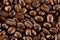 Brown roasted coffee beans, seed on dark background. Aroma, black caffeine drink. Closeup isolated energy mocha