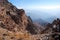 Brown rock on the background of the panorama of mountains of Tien Shan