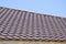 Brown roof of metal roofing on the sky background