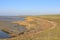 A brown salt marsh along the seawall in zeeland, holland in autumn