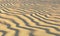 Brown sand on beach under evening sunlight