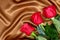 Brown satin fabric and roses closeup