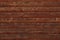 Brown shabby wooden planks. Surface of a wooden decrepit fence. Dilapidated oak planking. Texture of old brown boards. Grunge wood