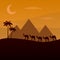 The brown silhouette of the caravan in the desert. Camels in the sands. African landscape. Camel Caravan Walking Across A egypt De