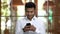 Brown-skinned hindu businessman texting message using his smartphone.