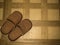 Brown Slippers on tile floor