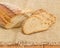 Brown sprouted bread and wheat ears on sackcloth closeup