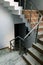 Brown stairway with simple stainless steel railings. Indoor. Home. Office. Empty