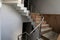 Brown stairway with simple stainless steel railings. Indoor. Home. Office. Empty