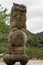 Brown stone statue of monster at itsukushima Shinto Shrine.