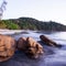 Brown stones on tropical sand beach at dusk