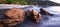 Brown stones on tropical sand beach at dusk