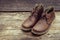 Brown stylish boots on wood background,  retro color